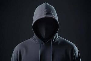 A mysterious figure in a black hoodie stands against a dark backdrop, creating an enigmatic atmosphere of suspense and intrigue photo