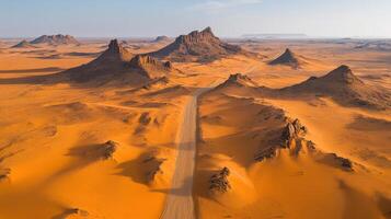 Expansive aerial view of desert landscape with dramatic rock formations and sandy terrain photo