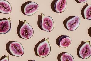 Fresh purple fig halves arranged in pattern on light background for food stock photo