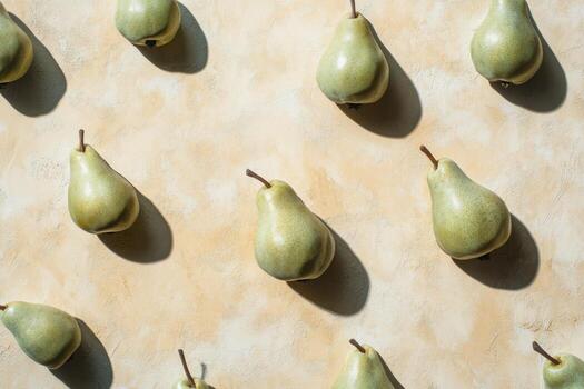 Multiple fresh pears arranged on a light surface creating a geometric pattern. photo
