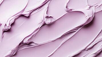 Smooth lilac cream texture swirls on soft pink background for skincare concept photo