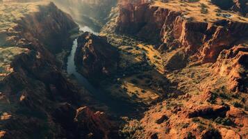 Aerial view of grand canyon with sunlit rocky formations and winding river course photo