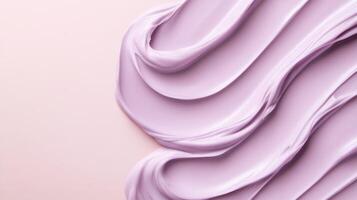 Smooth lilac cream texture swirls on soft pink background. photo