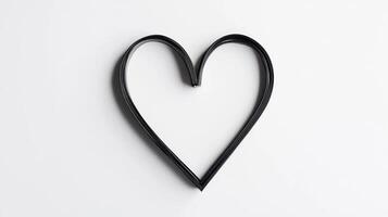 Minimalistic heart shape made from black wire on white background photo