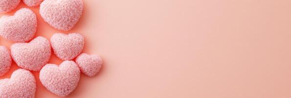 Pink fuzzy heart-shaped decorations on soft pastel background, love concept photo