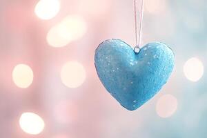 Light blue heart hanging on a string with sparkling glittering bokeh lights photo