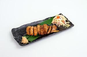 Chicken steak with teriyaki sauce and cabbage salad photo