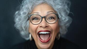 Energetic Black woman with curly hair smiling widely indoors. Concept of excitement and joy photo