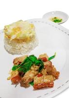 Stir Fried Spicy Crispy Pork with Basil On Rice and Fried Egg, focus selective photo