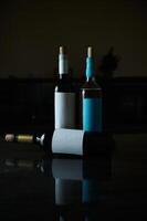 Elegant composition of wine bottles with blank labels on reflective surface photo