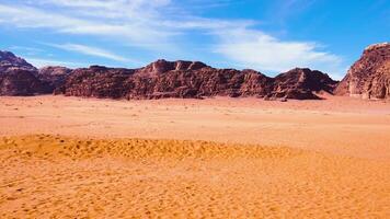 Majestic shot of an empty desert showing amazing rock formation under a blue cloudy sky video
