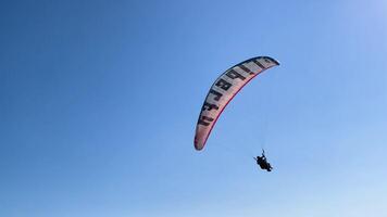 Paraglider Flying Above blue Ocean With Scenic Mountain and Island View during summer video