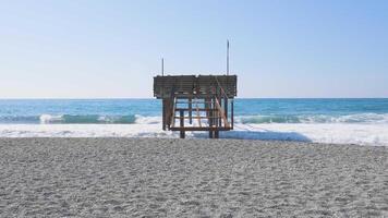 Clear Blue Ocean Water Waves Crashing Into Wooden Boardwalk Bay And Beach Shore on a sunny day during summer. Alanya beach Turkey with beautiful sky and clear water video