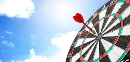 Darts on target with sky background photo