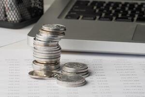 Stack of coin on financial report document photo