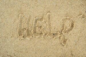 help word in the sand background photo