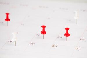 background of calendar and push pin stack on it photo