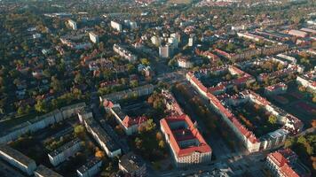 Aerial view of Wroclaw, Poland. Bird eye view of cityscape with colorful autumn trees and red roofs. City neighborhood with residential buildings and many green spaces in European city video