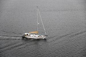 a sailboat heading out to sea photo