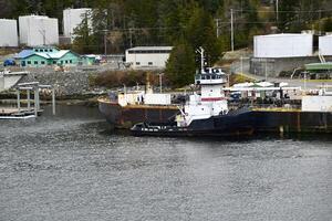 an oil barge and tugboat at a fuel terminal photo