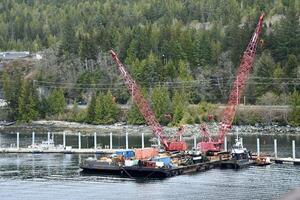 two old barges with cranes waiting for work photo