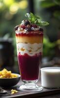 Delicious fruit dessert with yogurt and muesli in a glass photo