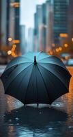 an umbrella with blue and black colors in the water photo