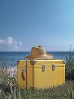 a new yellow suitcase is placed on the grass, with a blue sky and white clouds in the background. The hat sits atop it photo