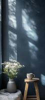 Minimalist interior design of a dark blue wall with a wooden table, a striped blanket, and a vase photo