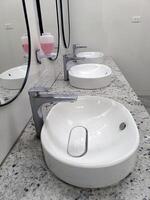 white sinks in public restroom photo