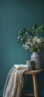Minimalist interior design of a dark blue wall with a wooden table, a striped blanket, and vase photo