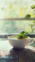 Steaming cup of mint tea on wooden table with sunlight, relaxation and refreshment concept photo