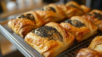 Freshly baked croissants on a cooling rack in a bakery, close-up view. Culinary art and artisanal baking concept photo