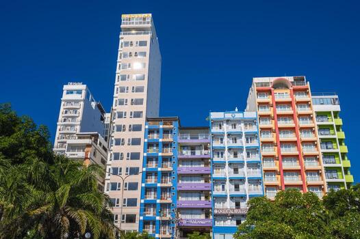 Facades of hotel skyscrapers against the blue sky in resort town in summer. Nha Trang, Vietnam - August 3, 2024 photo