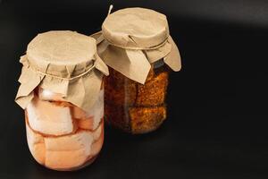Homemade canned food featuring boiled lard and pickled beans in jars photo
