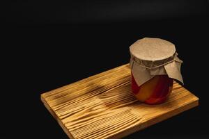 Homemade pickled vegetables in a jar on rustic wood table photo