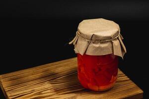 Homemade canned food featuring preserved peppers and vibrant colors photo