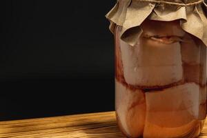 Homemade pickled lard and beans preserved in a glass jar photo