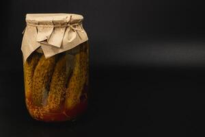 Homemade pickled cucumbers in a jar ready for storage and enjoyment photo