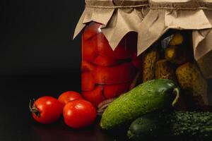 Homemade pickled vegetables with tomatoes, cucumbers, and peppers photo