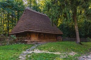 Experience local history at a charming wooden house in a serene park setting photo