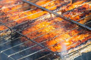 Grilling salmon and trout on barbecue for a tasty outdoor feast photo