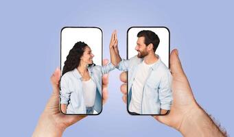 A married couple shares a joyful moment as they communicate online using smartphones. Their playful interaction highlights love and connection through technology in everyday life. photo