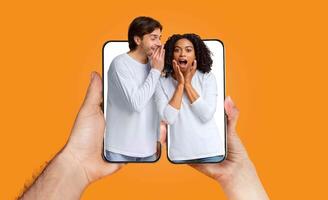 A man and woman share an excited conversation while holding a smartphone. Their expressions show joy and surprise as they connect through technology. This captures modern relationship dynamics. photo