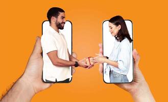 A couple expresses their love while using smartphones. They appear to be communicating and sharing a moment together, showcasing modern relationship dynamics. The background is bright orange. photo