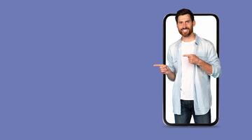 A person showcases a large smartphone screen while pointing, highlighting social media applications. The isolated background emphasizes modern communication technology. photo