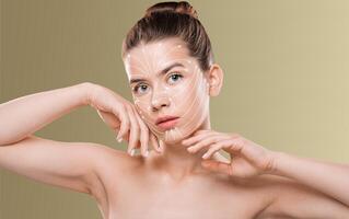 A woman is applying a skincare routine, focusing on pampering her skin with gentle techniques. The setting is isolated with a neutral background, emphasizing her beauty ritual. photo