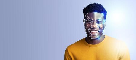 A user smiles while facial recognition technology analyzes their features. The background is minimal, emphasizing the innovative use of technology for personal identification. photo