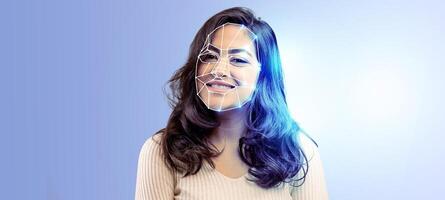A smiling individual is highlighted with digital facial recognition technology. The modern, isolated backdrop emphasizes data analysis and identification concepts. photo