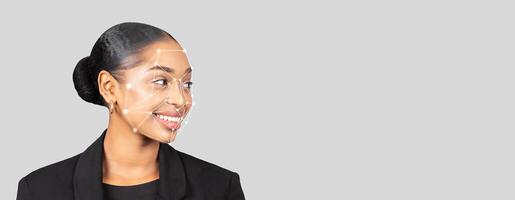 A professional woman is highlighted for facial recognition technology. The concept showcases the identification process, featuring clear facial mapping points against a neutral background. photo